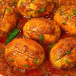 "Dhaba-style egg curry garnished with fresh coriander leaves"
